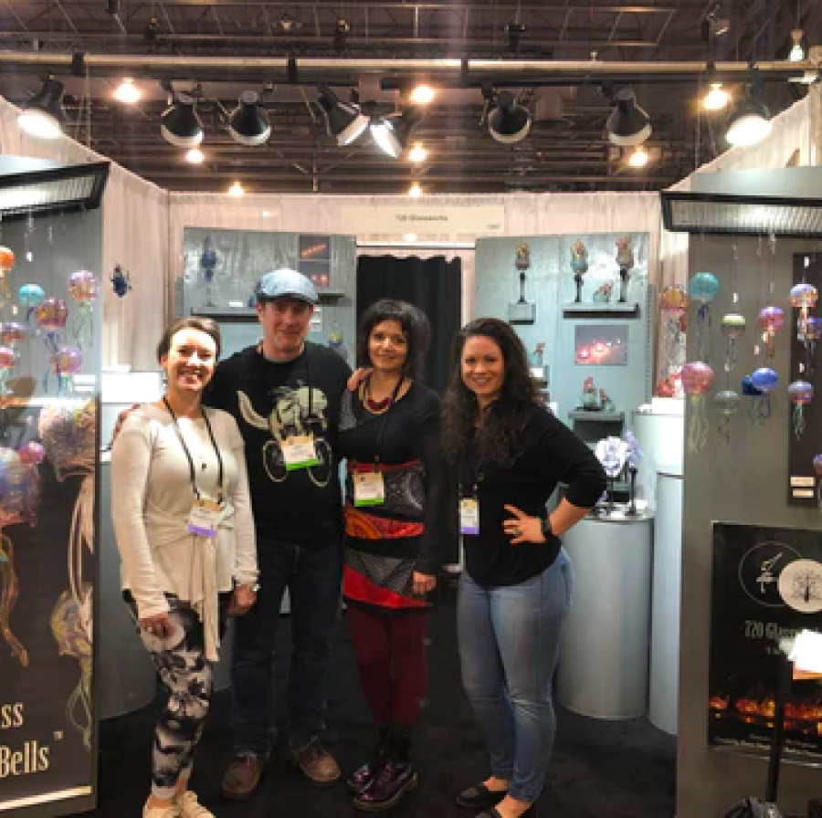 Image of Andrea and James of 720 Glassworks at one of their shows in their booth with customers.